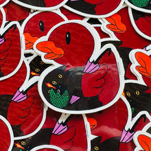 Load image into Gallery viewer, Stack of rubber duck stickers. The ducks are dressed up. They are red with a long coat with gold buttons. By it is a little dragon egg hatching and blowing fire. The duck is holding a pink umbrella.